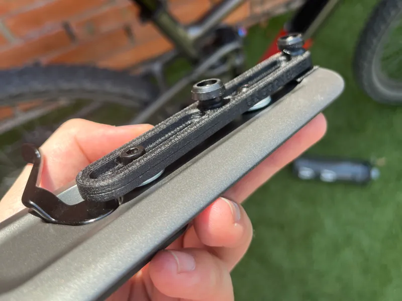 Adjustable bike bottle cage relocator