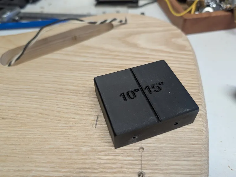 Drill guide for bass guitar bridge ground wire