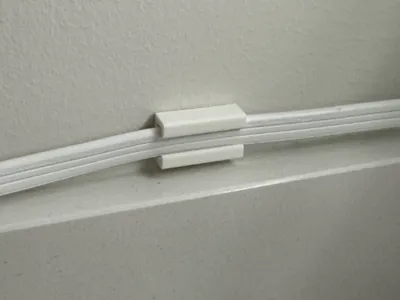 Power cable clips that use small command stips