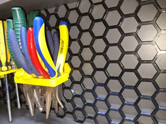 Pliers holder for honeycomb storage wall