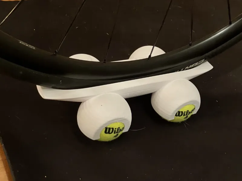 Front wheel rocker foot for dyno trainer