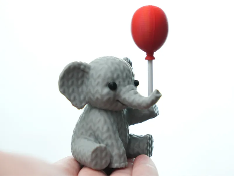 Knitted Elephant holding balloon