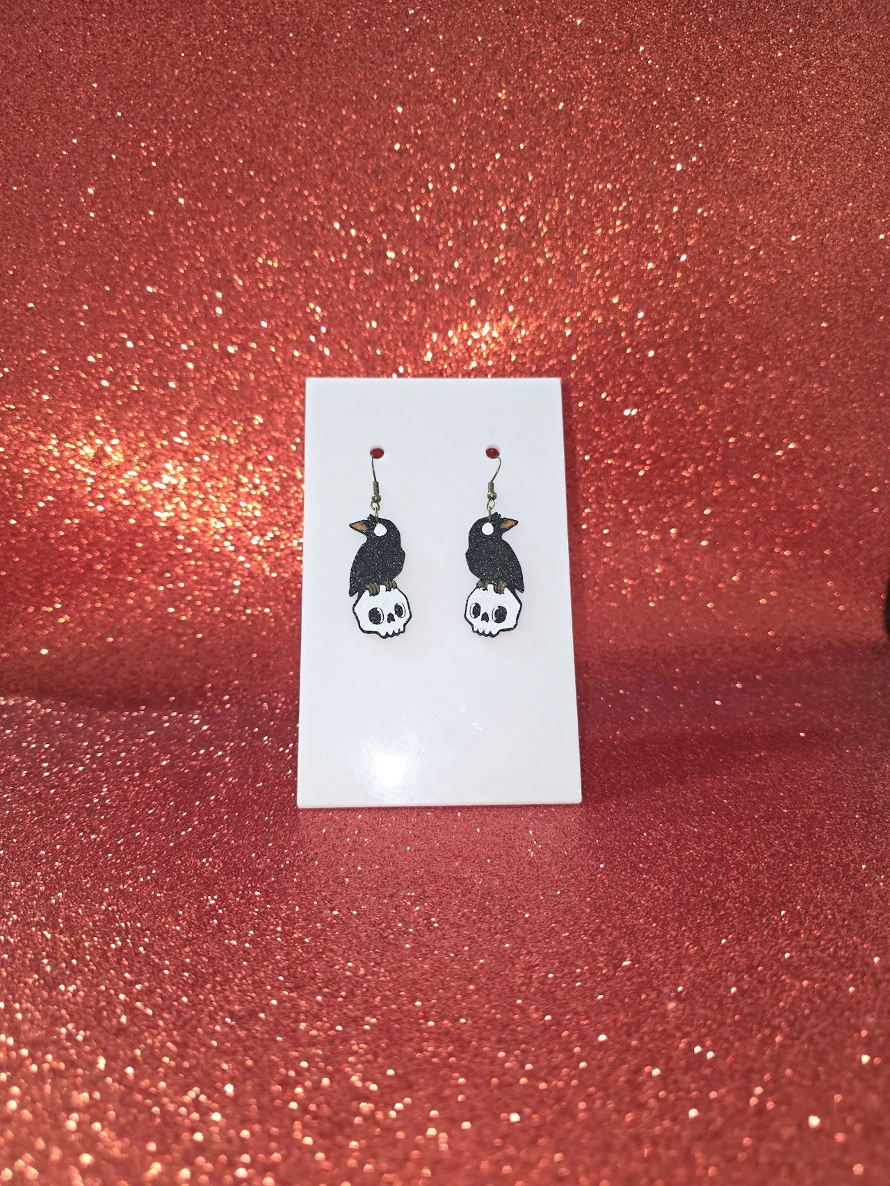 Crow on skull earrings view 2