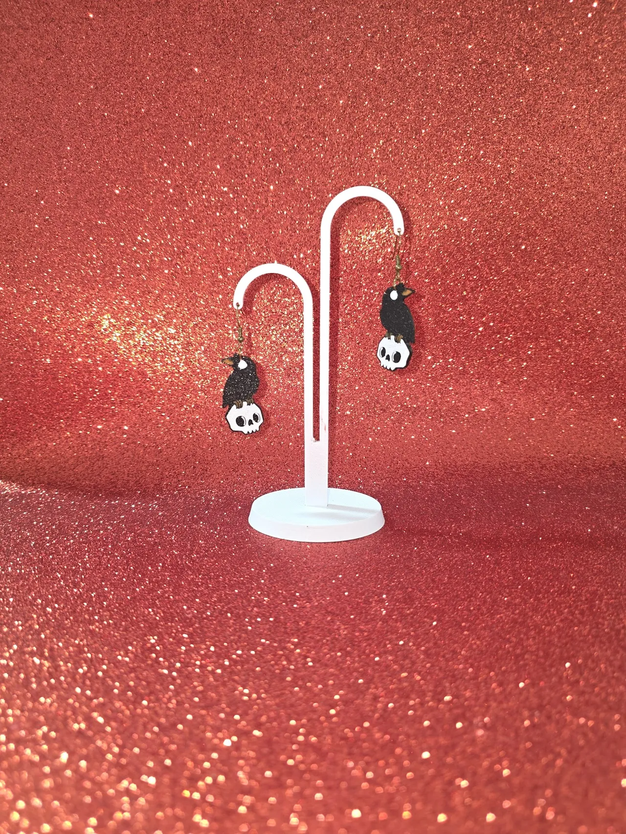 Crow on skull earrings view 3