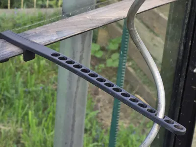 Tomato stake holder for greenhouse