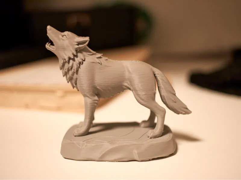 Wolf howling on a rock