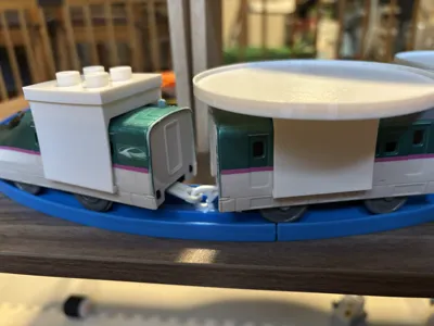 Adapter for placing toys on Plarail
