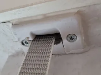 Roller shutter belt feed-through with cover