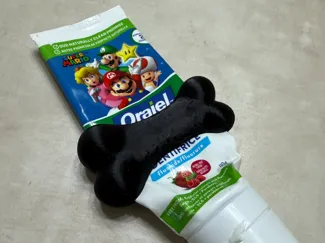 Dog bone toothpaste squeezer