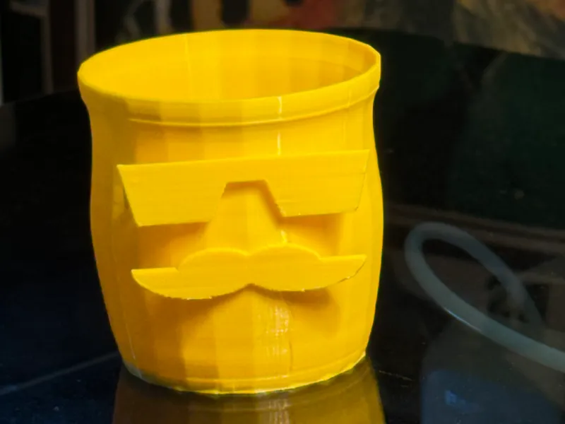a small jar with a mustache