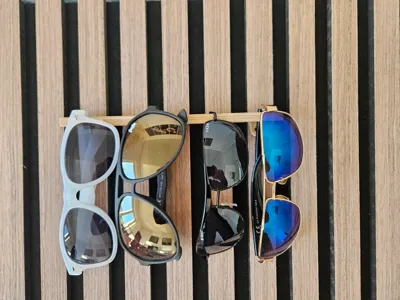 Glasses holder for cabinet or acoustic panels