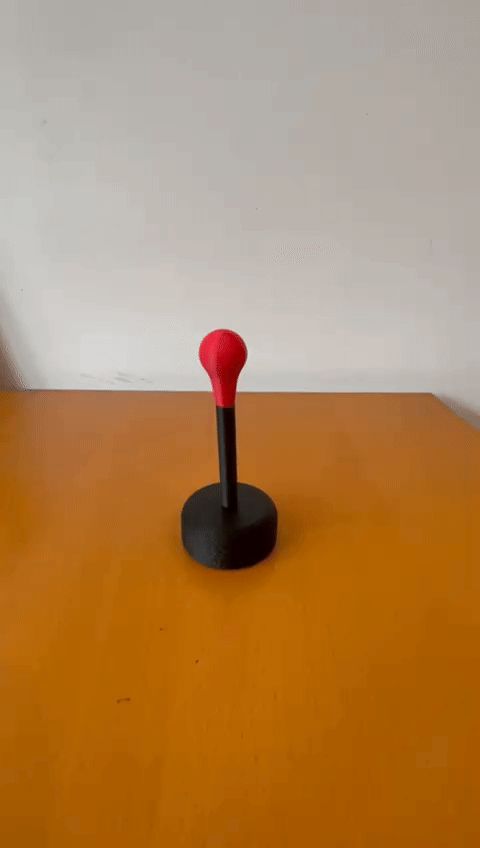 Mini sping-loaded desktop punching bag fidget