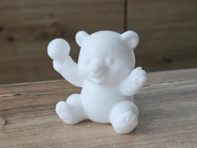 Cute Polar Bear With a Snowball