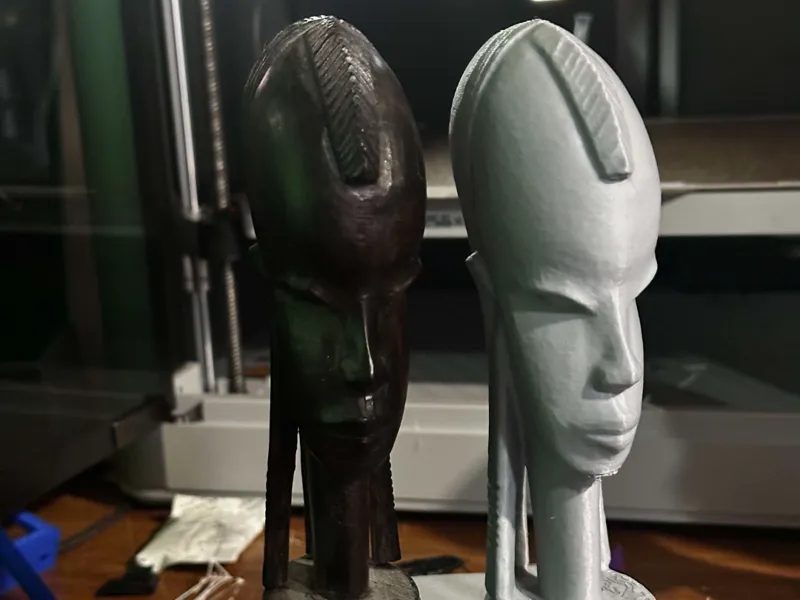 African wood carved statue with ponytail