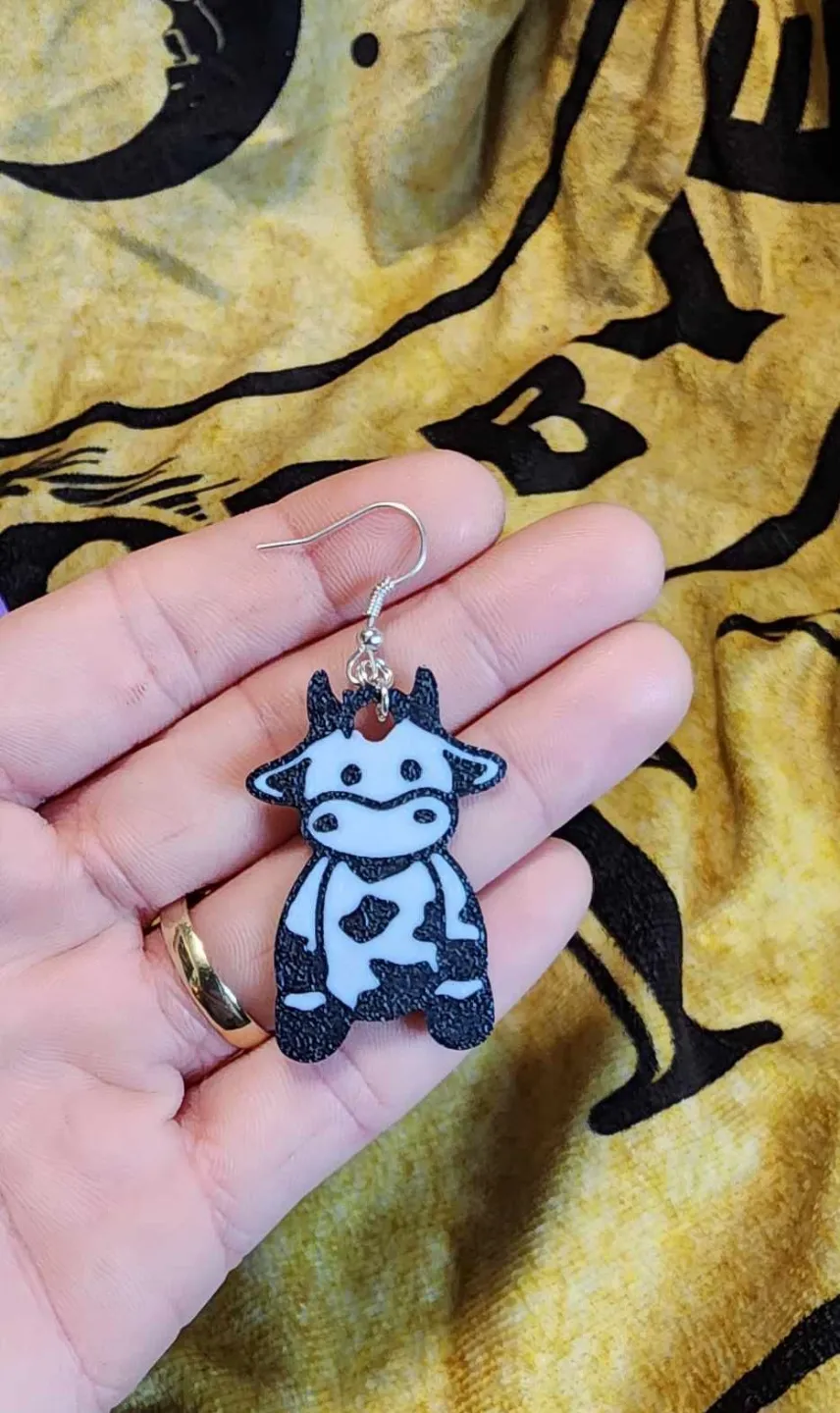 Sitting cow earrings view 2