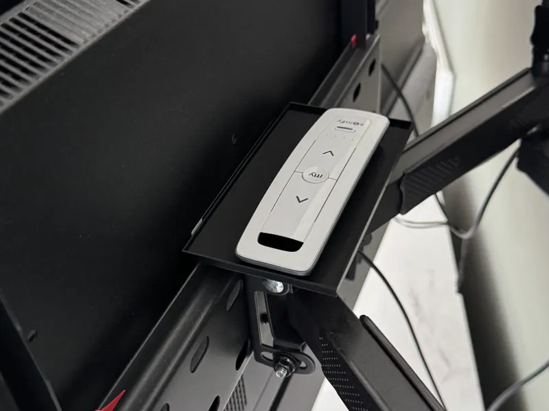 Remote storage shelf behind tv wallmount