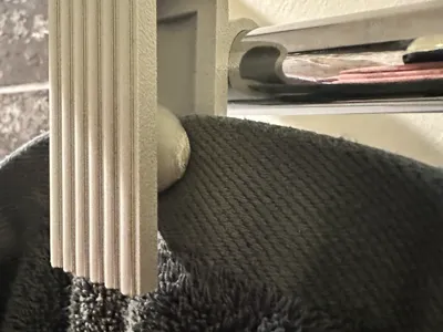 Gravity hook for towels on heater
