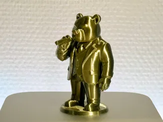 Bear wearing a suit and holding cigar