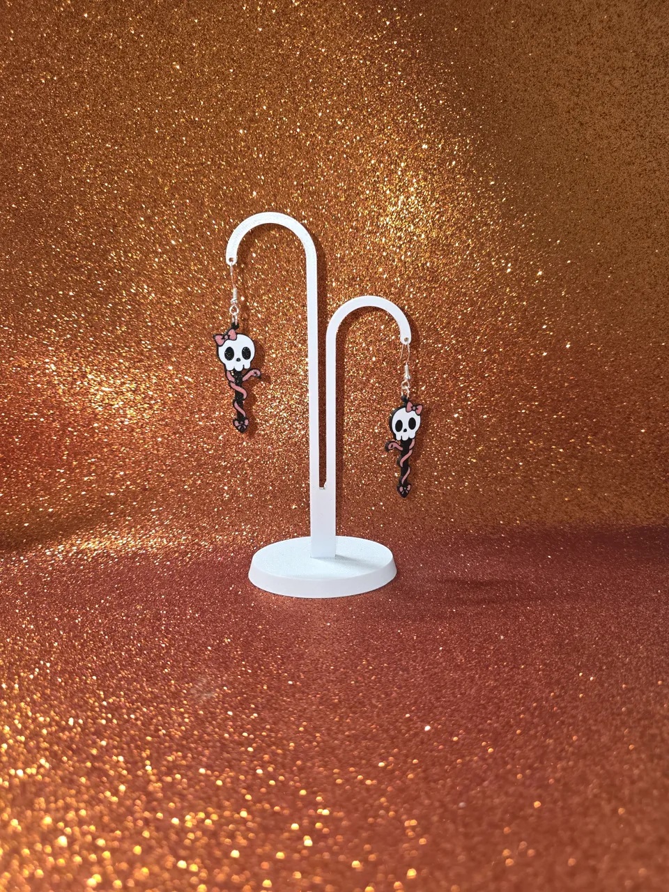 Skull and snake charm with bows earrings view 3