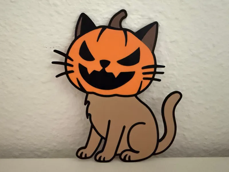 Cat wearing a spooky pumpkin