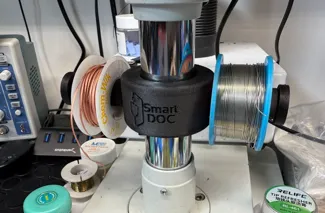 Tin reel support for microscope