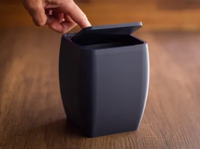 Desktop trash bin with lid.