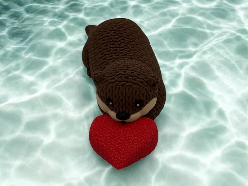 Cute lying Knitted Otter with optional Heart