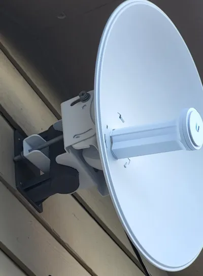 Wall mount for pole-mounted antenna