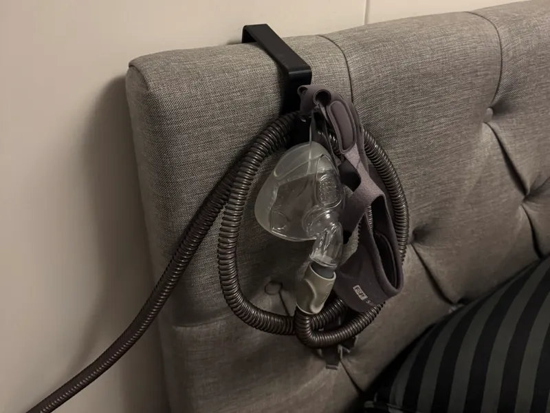 Holder for CPAP mask to hang on bed headboard