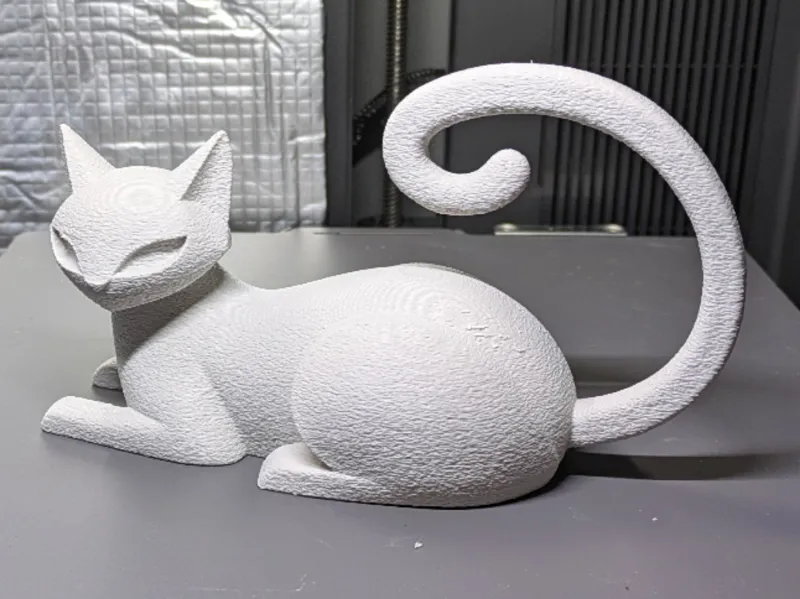 Cat relaxed figure with long tail curved