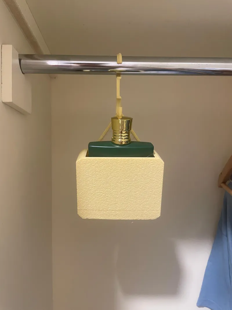 Perfume / cologne holder for closets .