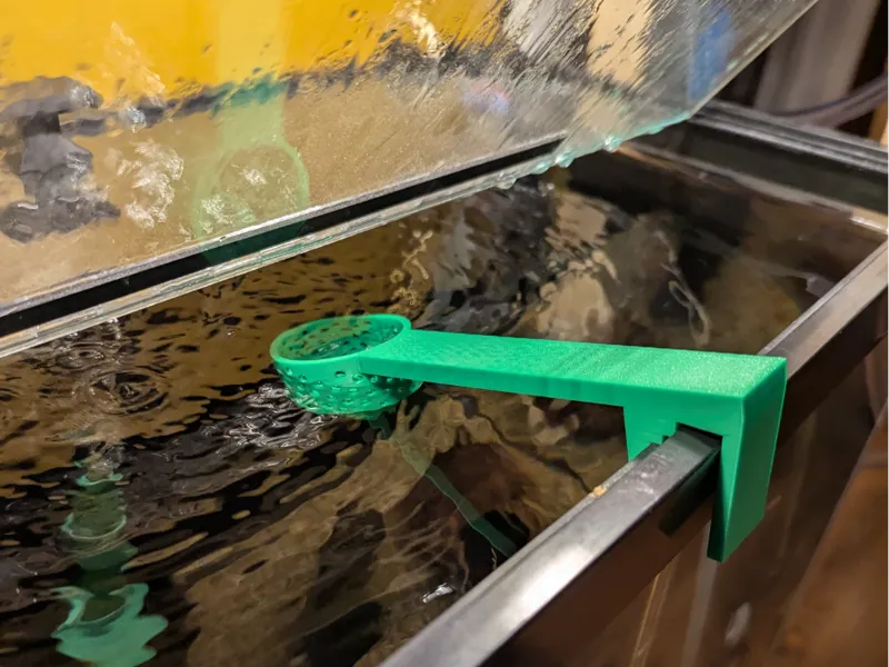 Frozen food dispenser for framed aquarium