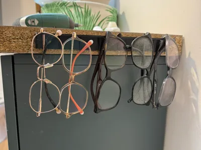 Wall-mounted or furniture-mounted glasses holder