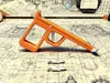 rubber band blaster, capable of firing folded paper bullets