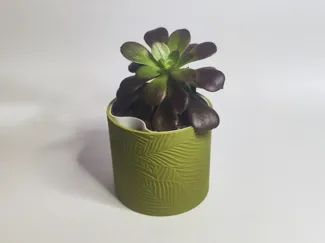 Self watering planter with floral pattern