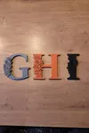 G H I