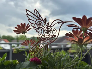Floraler Vogel Kolibri mit Blumenstecker