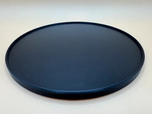 Dessous de verre rond 100x5 mm avec rebord (uni)