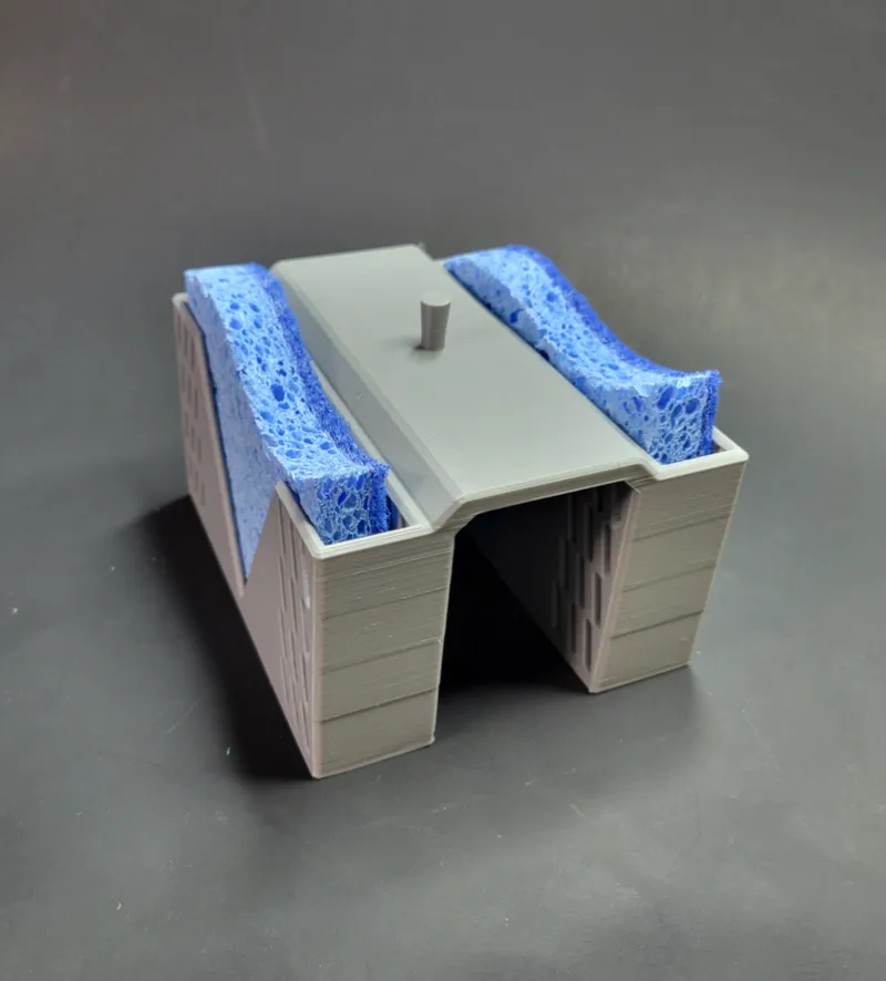 Sponge caddy for a split basin sink  