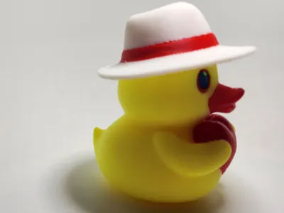 Duck with hat holding heart.