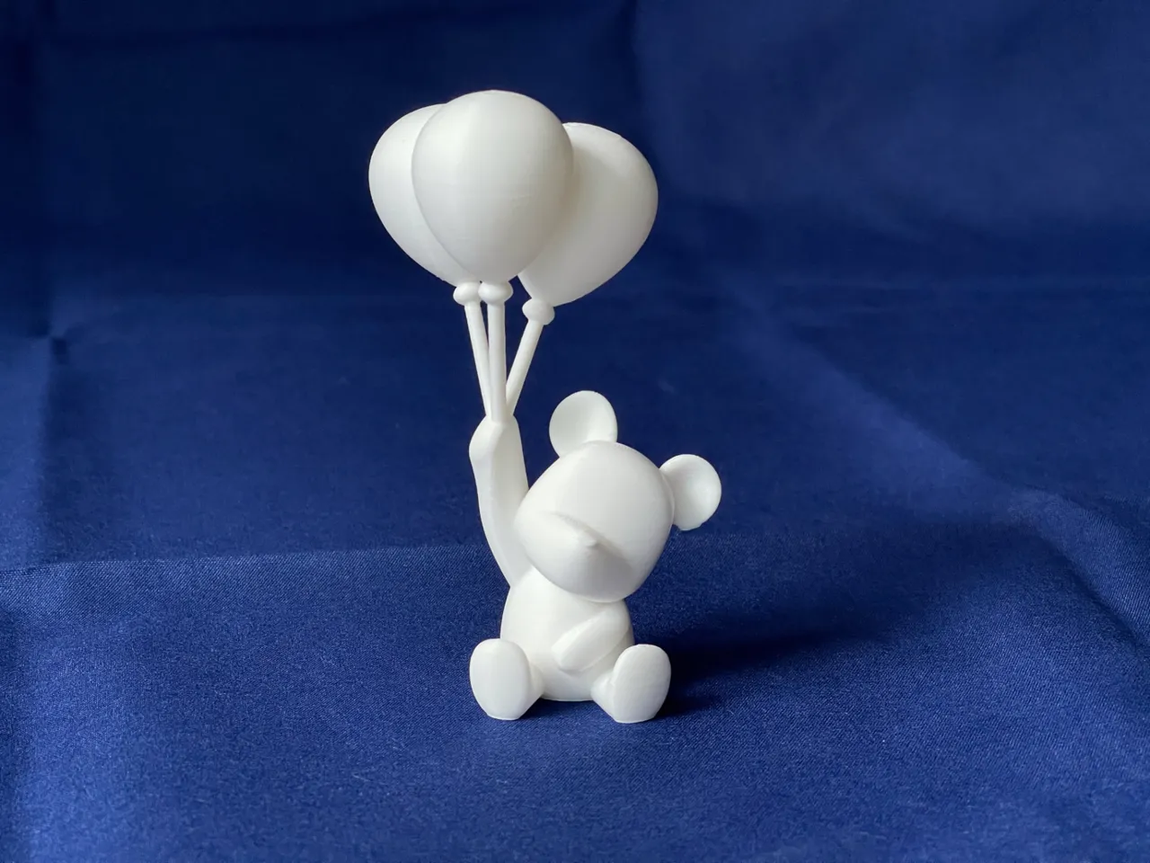 Polar bear holding balloons view 3