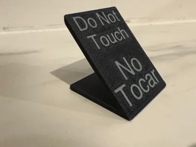"do not touch" sign in english and spanish
