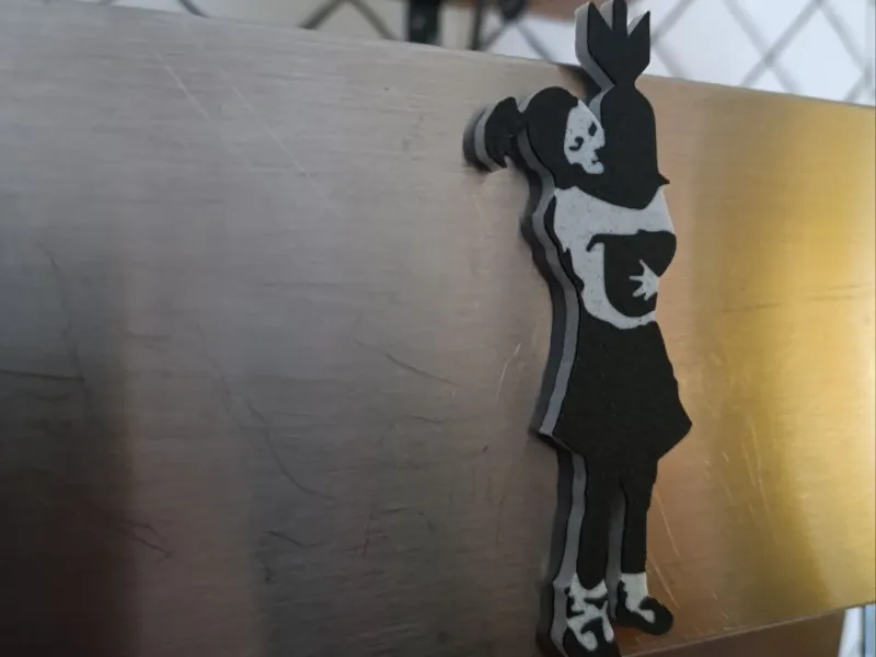 Girl hugging bomb - Banksy magnet