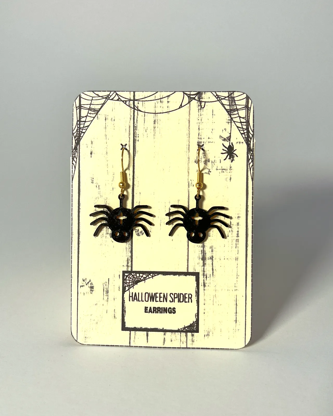Halloween spider earrings with gift background view 2