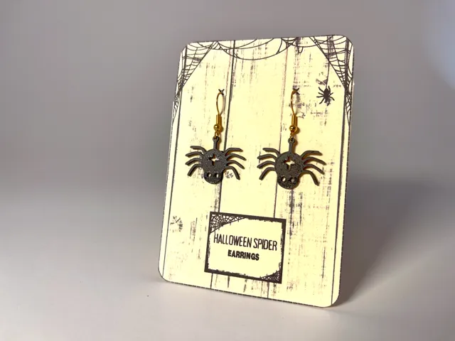 Halloween spider earrings with gift background