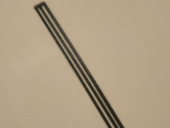 Nut slot shim for acoustic guitars