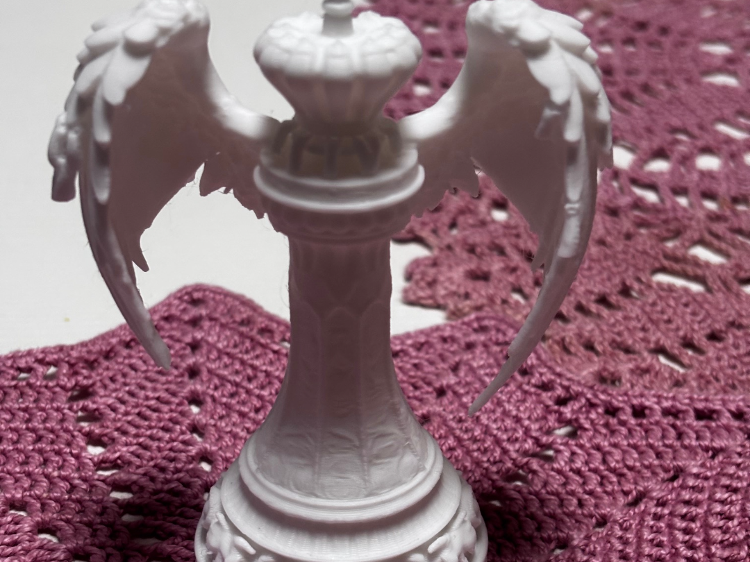 Queen with wings chess piece