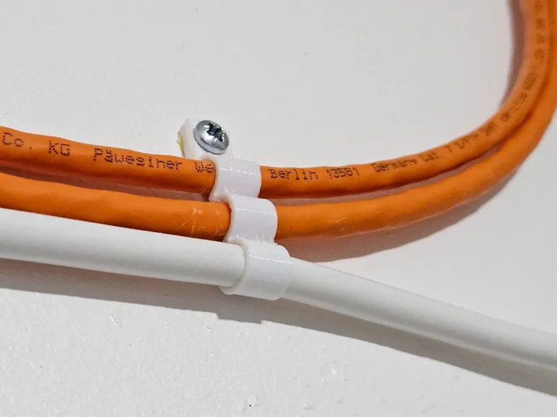 Wall-mounted cable clips with screw hole