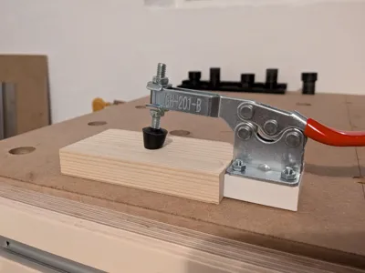 Hold-down clamp for pegboard or T-slot