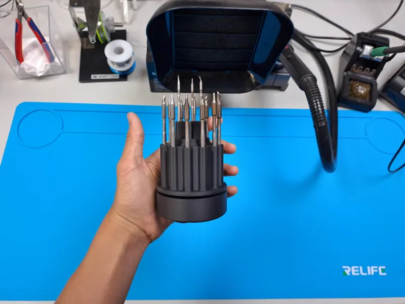 Soldering tip holder on rotatable weighted base.